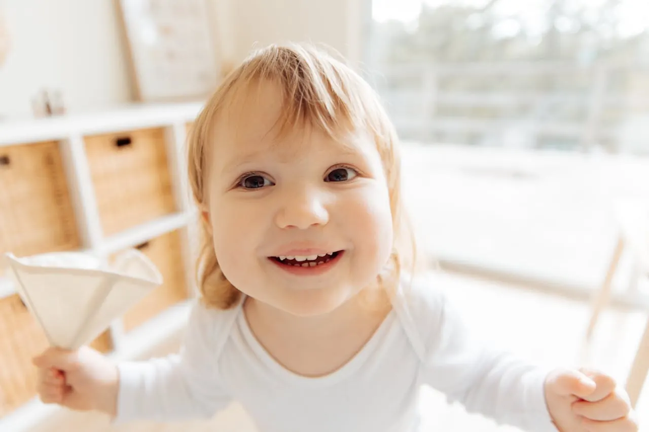 A happy toddler smiling at home